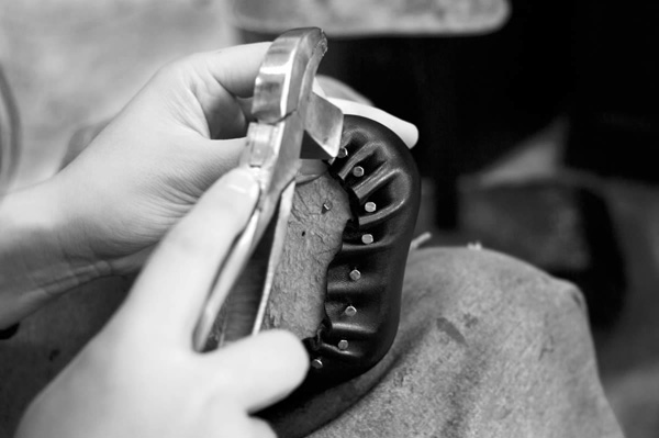 出来上がったアッパーを木型に定着させる作業。靴の形が決まるとても大切な工程です。